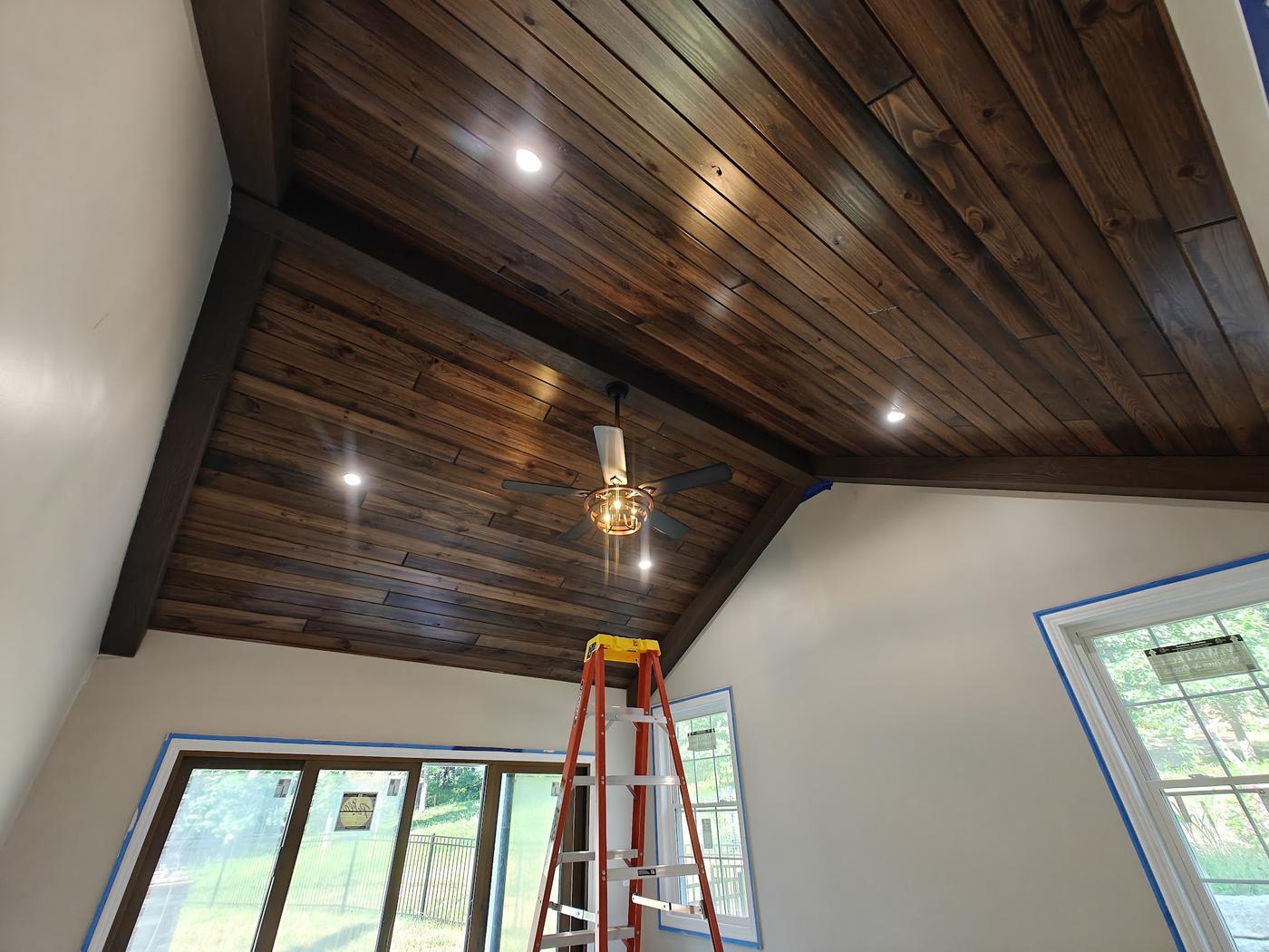 Vaulted shiplap ceiling with recessed lights and a ceiling fan, ladder still up mid-job
